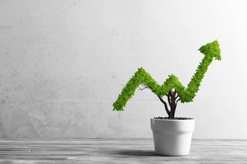 Green upward-trending growth arrow emerging from a small plant pot