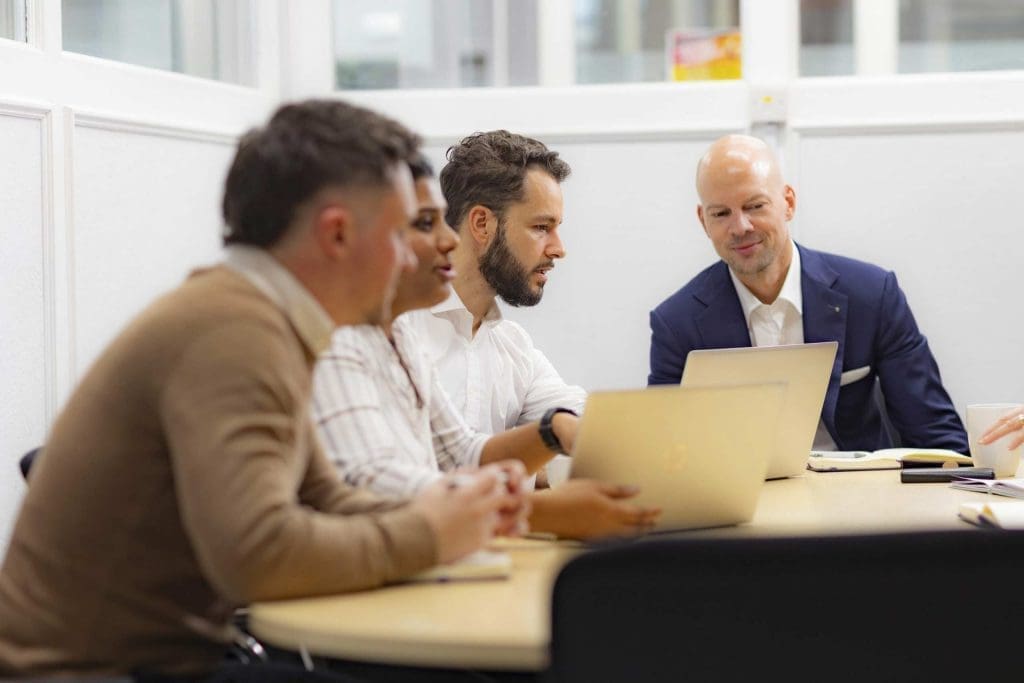 Business professionals collaborating during a meeting around a table.